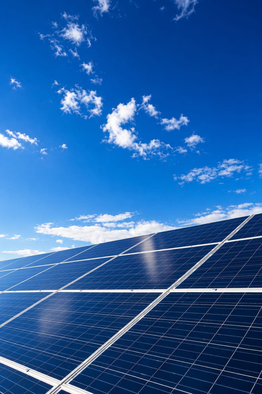Rooftop solar panels against a blue sky