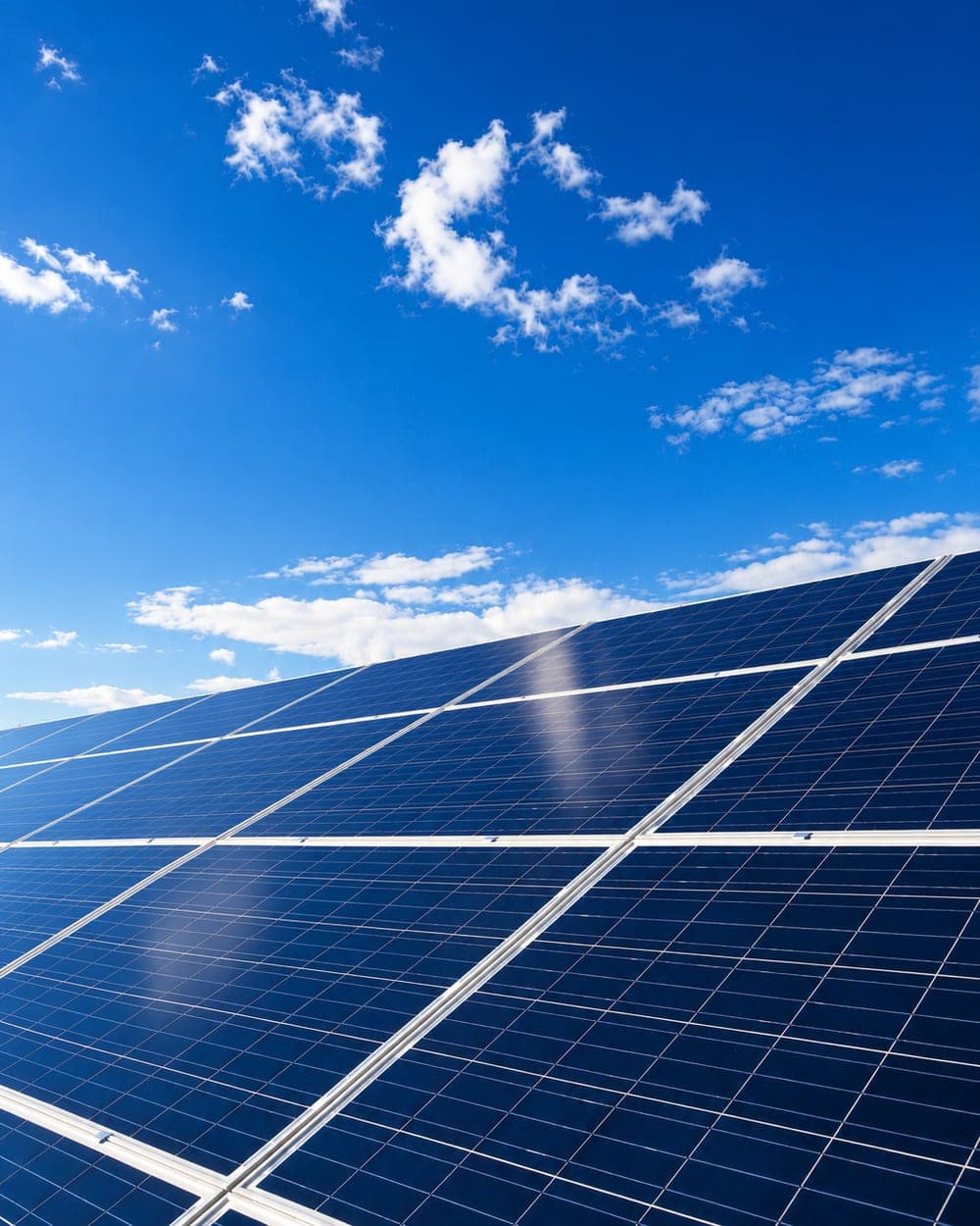 Solar technician performing maintenance on panels